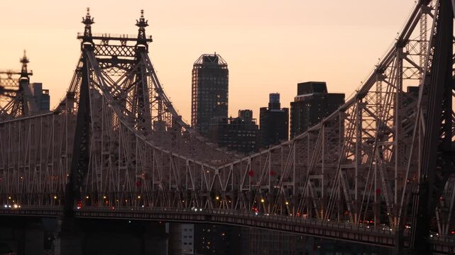 New York City Manhattan Midtown skyline from Queens, Queensboro bridge architecture, United States. Cityscape from rooftop in Long Island, Hunters Point. Urban sunset over transport metallic bridge.