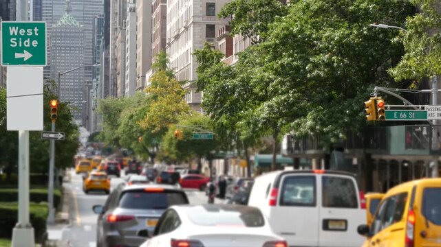 Manhattan Midtown East straight street, Park avenue New York City Turtle bay, United States. Yellow taxi car, urban road traffic. Summer green trees on boulevard. Transport and greenery in East Side.