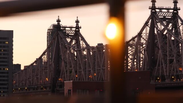 New York City Manhattan Midtown skyline from Queens, Queensboro bridge architecture, United States. Cityscape from rooftop in Long Island, Hunters Point. Light bulbs garland on roof, urban sunset.