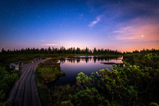 Starry Night over Lovren&scaron;ka Jezera Peat Bog Lake with Wooden Footbridge, Pohorje Slovenia   