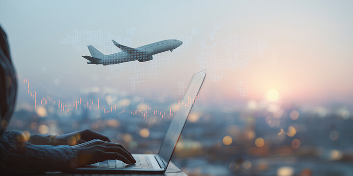 A person types on a laptop overlooking a glowing skyline with flight charts.