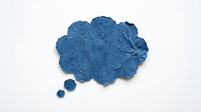 Handmade blue paper thought bubble shape with rough deckled edges isolated on white background