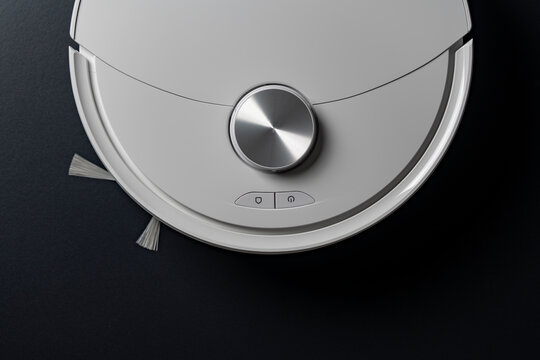 White robot vacuum cleaner, top view, closeup. Modern white robotic vacuum cleaner with metallic lidar sensor and control buttons on black background