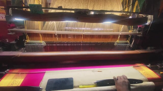 4K video of a colorful saree being woven on a power loom, showcasing the textile manufacturing process and industrial production of traditional Indian clothing.