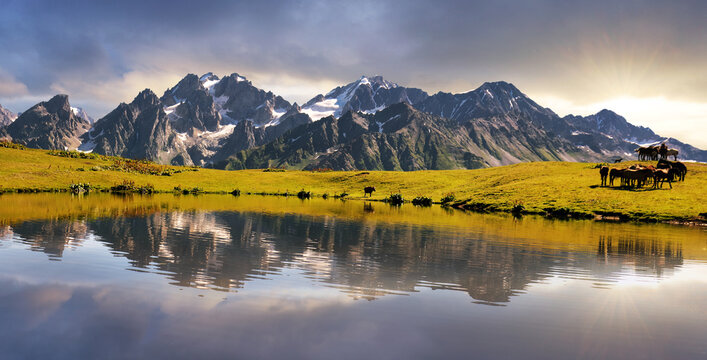 Koruldi mountain lake at dramatic sunrise with sun. Upper Svaneti, Georgia, Europe Caucasus mountains