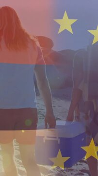 Vertical video: Travel group walking shore to set up spot, cam tracking behind stars overlay moving