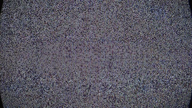 Television static transitioning to black screen with glitch effects during broadcast interruption in dark studio
