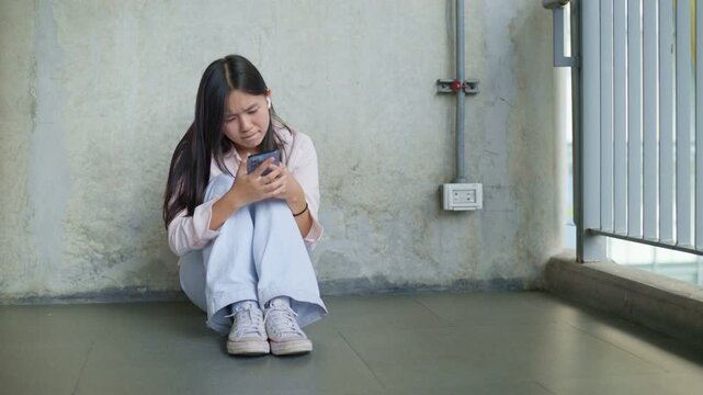 anxious worried teen girl with her smartphone as a conceptual footage for cyberbullying social media trauma, teenager mental health crisis, depression and panic attack