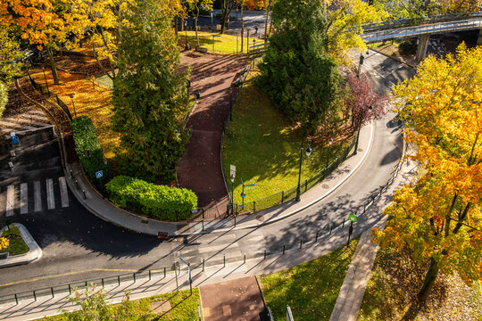 An overhead view of curved roads paths and autumn trees in La Defense in Paris France shows landscaped public space woven into the contemporary urban district