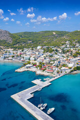 Fototapeta premium Aerial view of the coastal town Agia Marina on the Greek island of Aegina, Saronic Gulf, Greece, during a sunny summer day