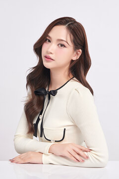 A beautiful young Asian woman with clean, fresh skin against a white background. Skincare, facial treatment, cosmetology, beauty, and spa. An elegant portrait of an Asian woman.