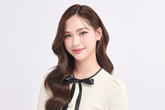 A beautiful young Asian woman with clean, fresh skin against a white background. Skincare, facial treatment, cosmetology, beauty, and spa. An elegant portrait of an Asian woman.