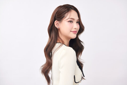 A beautiful young Asian woman with clean, fresh skin against a white background. Skincare, facial treatment, cosmetology, beauty, and spa. An elegant portrait of an Asian woman.