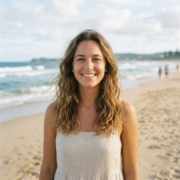 Happy Young Woman Smiling At The Beach With Ocean Background