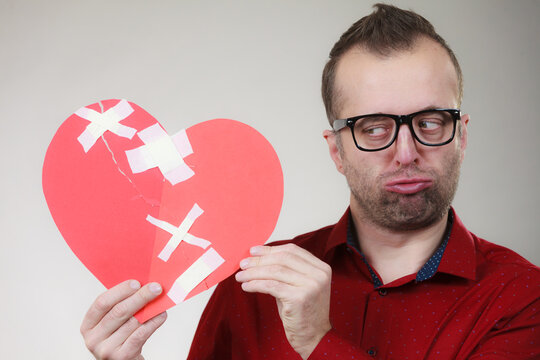 Funny man holds broken heart