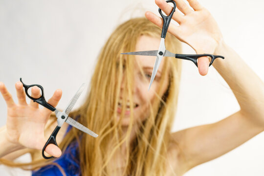 Girl with scissors for haircutting