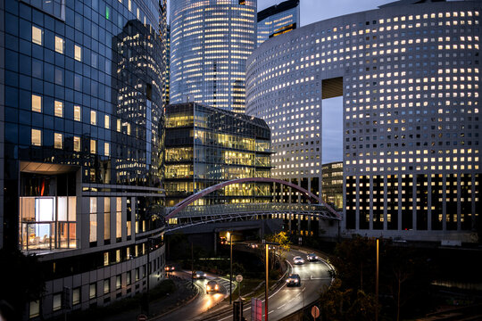 Evening cityscape of office towers and roads in La Defense Paris France showing illuminated modern architecture in a major business district