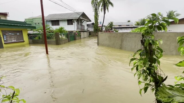 Road flooded between the houses in the village as a result of heavy rains and the monsoon.