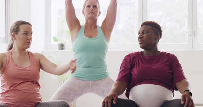 Fitness, yoga and pregnancy with women in class for pelvic floor health, flexibility and workout. Pilates, prenatal exercise and healing with group of people in studio for zen and wellness balance