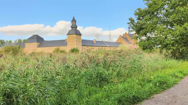 Herkenrode Abbey in Belgium shown from different angles with surrounding greenery