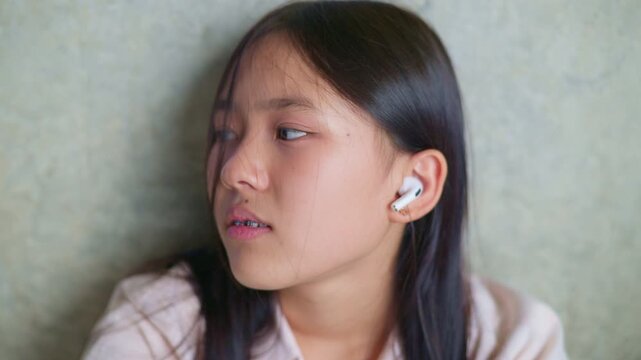 anxious worried teen girl with her smartphone as a conceptual footage for cyberbullying social media trauma, teenager mental health crisis, depression and panic attack