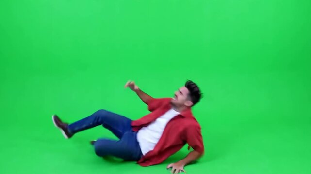Man falling down dramatically backwards on green screen background
