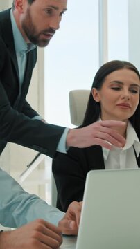 Multiethnic business team partners working with laptops indoor office coach mentor boss helping employees diverse ethnic coworkers interns explaining data project teamwork corporate meeting support