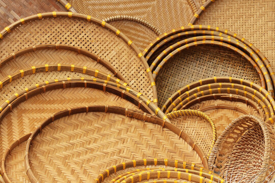 Detailed full frame abstract texture background of traditional Vietnamese woven bamboo sieve trays piled together in Hoi An, Vietnam.