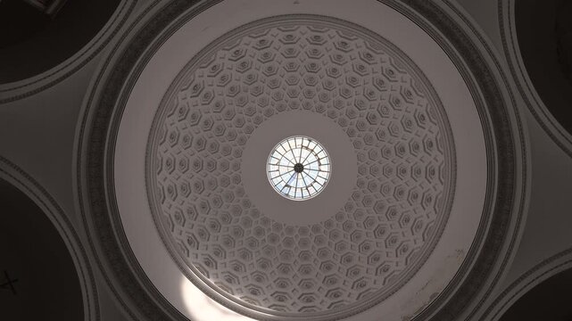 Camera looks straight up at the patterned dome and central oculus inside Basilica Reale Pontificia San Francesco da Paola.