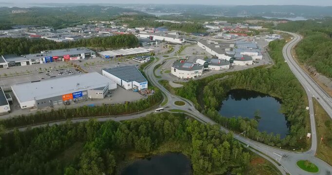 Aerial view of S&oslash;rlandsparken commercial district in Kristiansand Norway in slow motion showing grey pavement and urban landscape