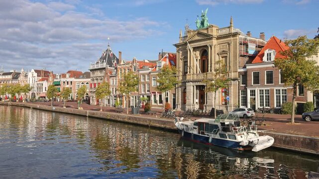 Picturesque panorama of Spaarne river canal featuring historic Teylers Museum and moored boat in Haarlem, Netherlands on 16 August 2026.

