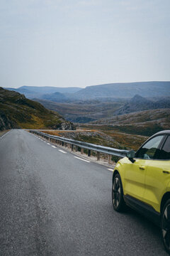Electric car on scenic mountain road in remote Northern Norway