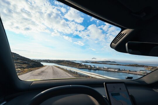 Scenic Arctic road trip view through car windshield in Northern Norway