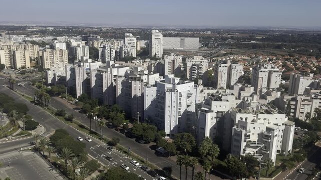 Netanya, Israel, 21 September 2026. Sunset view of the city with modern buildings and the Judean Hills on the horizon, photographed from a high-rise tower.