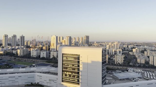 Netanya, Israel, 21 September 2026. Sunset view of the city with modern buildings and the Judean Hills on the horizon, photographed from a high-rise tower.