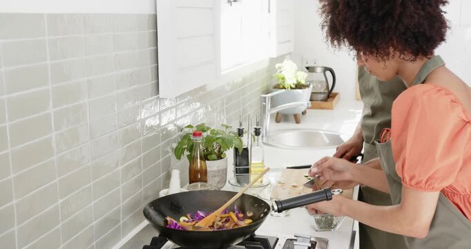 Lifestyle videos indoor of people doing activities at home, cooking together, couple preparing veget
