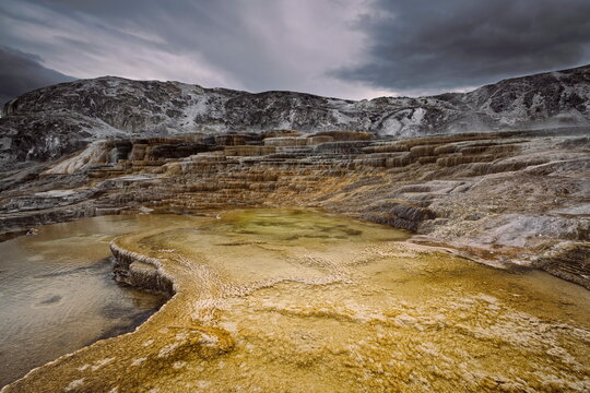 Mound and Jupiter Terraces, Mammoth Hot Springs: tiered, algae-and-bacteria-colored travertine pools under an overcast sky. Yellowstone NP-WY-USA-014