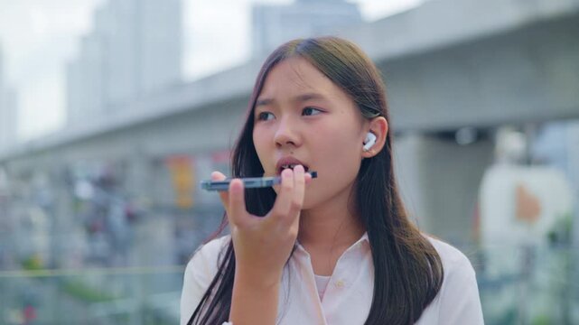 woman talking and command an AI voice assistant on a smartphone as a conceptual backdrop for artificial intelligence technology communication phone innovation virtual assistant and smart lifestyle