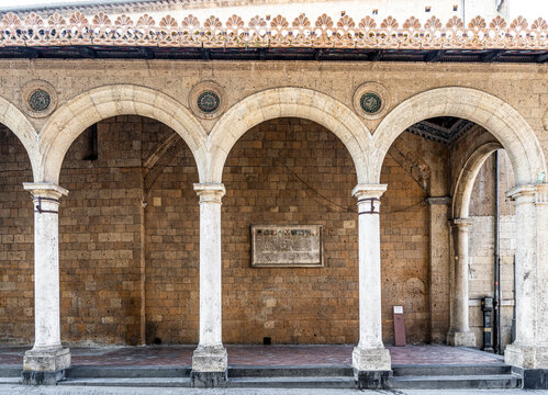 Historic portico of the Church of Sant'Andrea in Orvieto's medieval centre, an architectural feature associated with one of the city's oldest religious buildings, Orvieto, Umbria, Italy