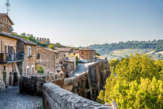 View of Orvieto's medieval historic centre along Strada di Porta Romana, featuring narrow streets, historic stone buildings and traditional urban architecture, Orvieto, Umbria, Italy
