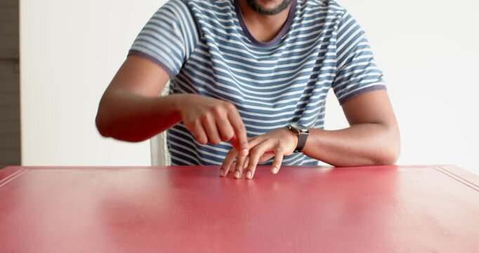 Close up of people talking to the camera, pointing at red table, man in striped shirt focusing on so