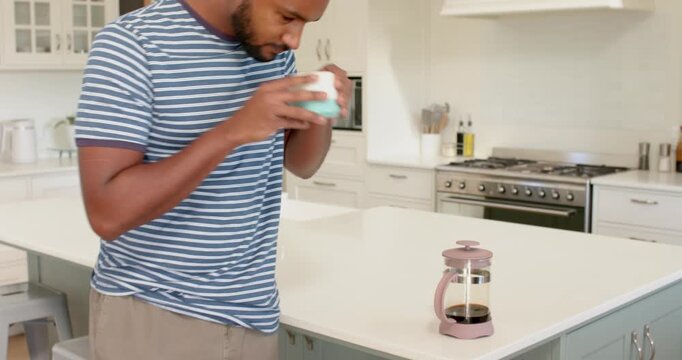 Lifestyle videos indoor of people doing activities at home, drinking coffee, man in striped shirt en