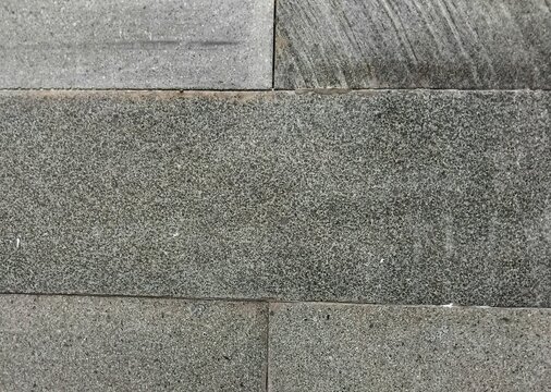 view of grey rectangular natural stone tiles with a rough surface