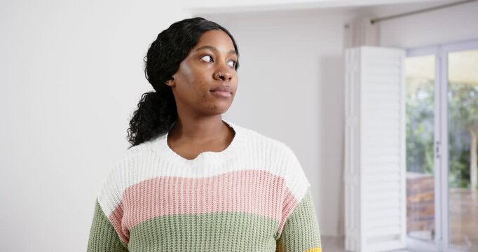 High speed photography for dynamic scenes, standing indoors, woman in colorful sweater looking to si