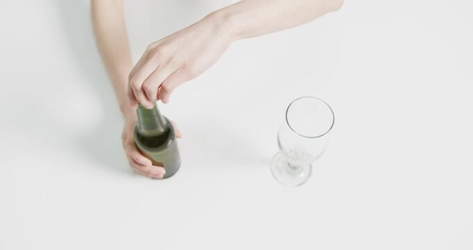 Lifestyle videos indoor of people doing activities at office, pouring beer from green bottle into gl