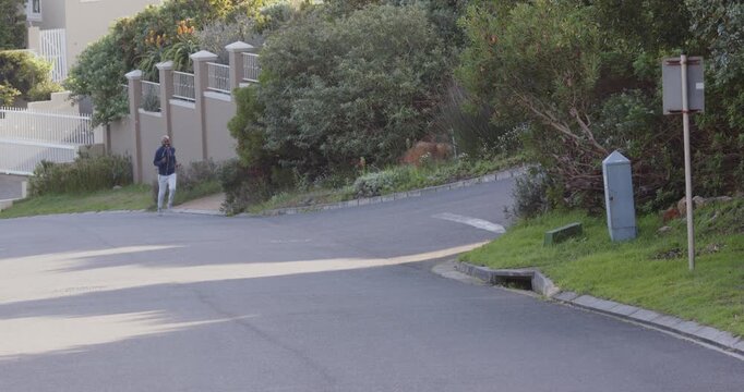 Lifestyle videos outdoor of people doing activities, walking on suburban street, man listening to mu
