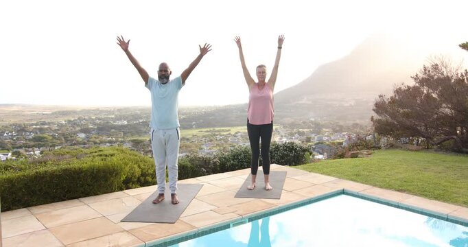 Lifestyle videos outdoor of people doing activities, practicing yoga on mats by pool, man and woman