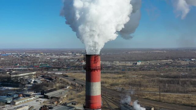 Close-up of a smokestack emitting smoke and smog. 
