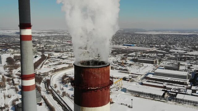 Close-up of a smokestack emitting smoke and polluting the air.

