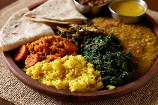 The Indian Thali Plate with Lentil Curry, Spinach Saag, Rice and Bread